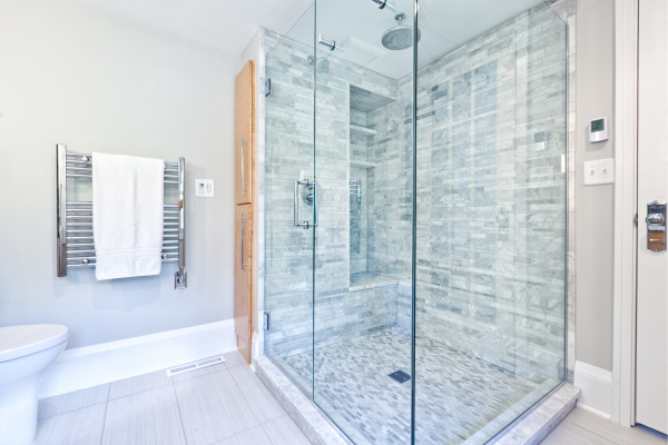 Shower glass enclosure in a blue bathroom remodel with sleek tile Shower glass enclosure in a blue bathroom remodel with sleek tile