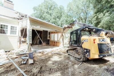 a bulldozer is parked in front of a house a bulldozer is parked in front of a house